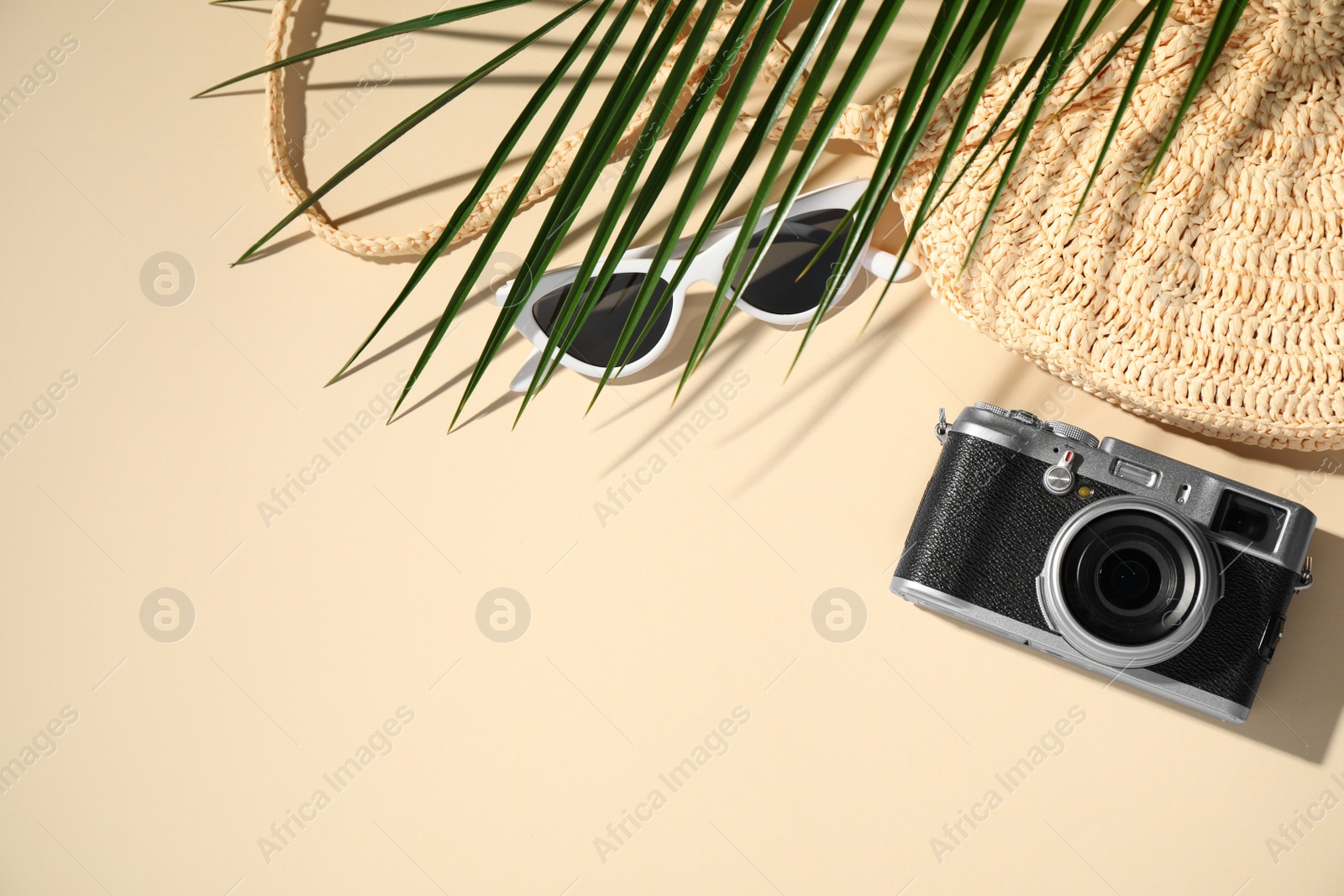 Photo of Flat lay composition with camera on beige background, space for text