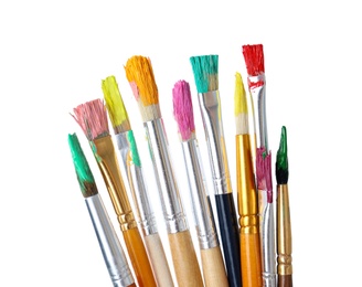 Different brushes with paints on white background