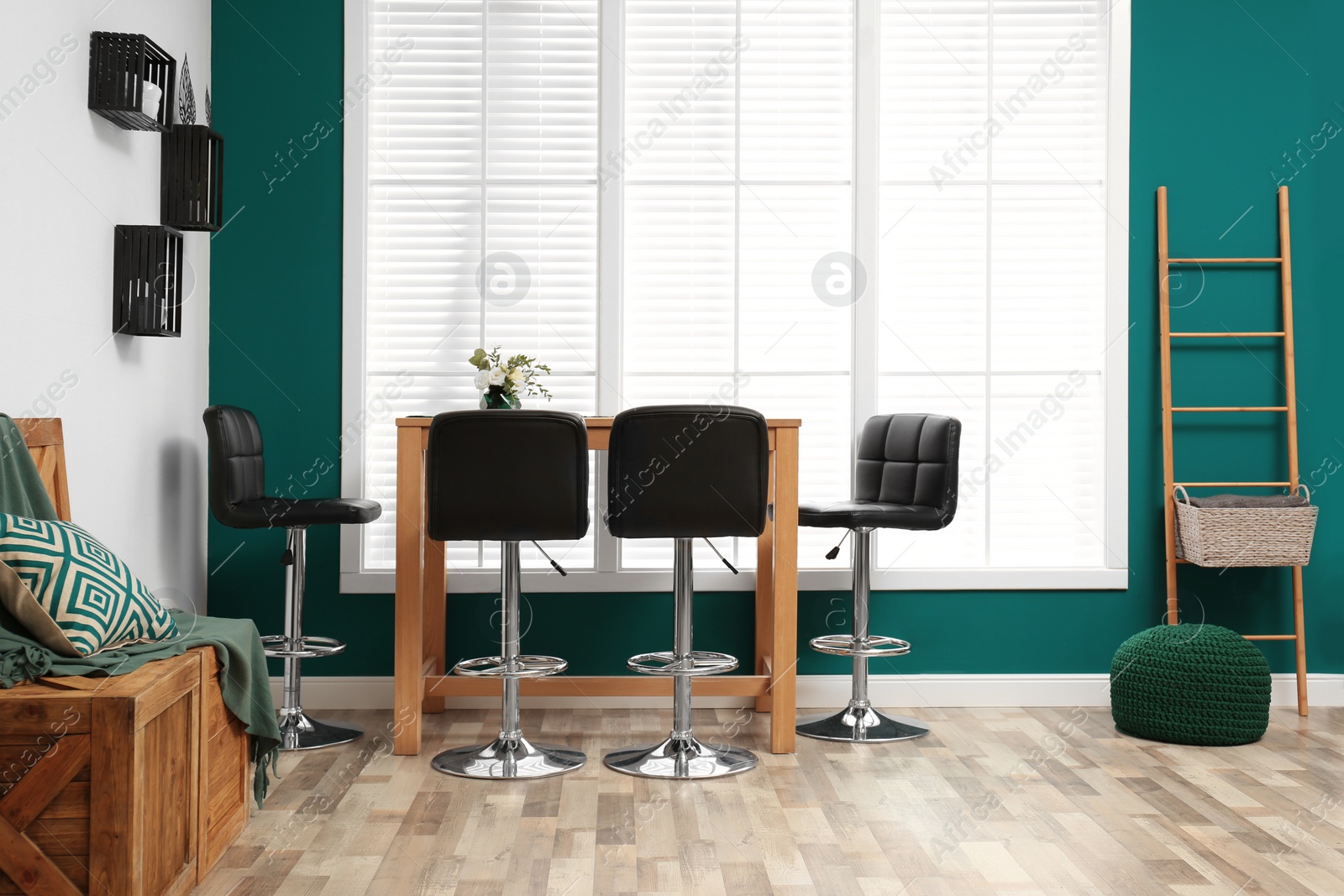 Photo of Elegant room interior with wooden table and bar chairs