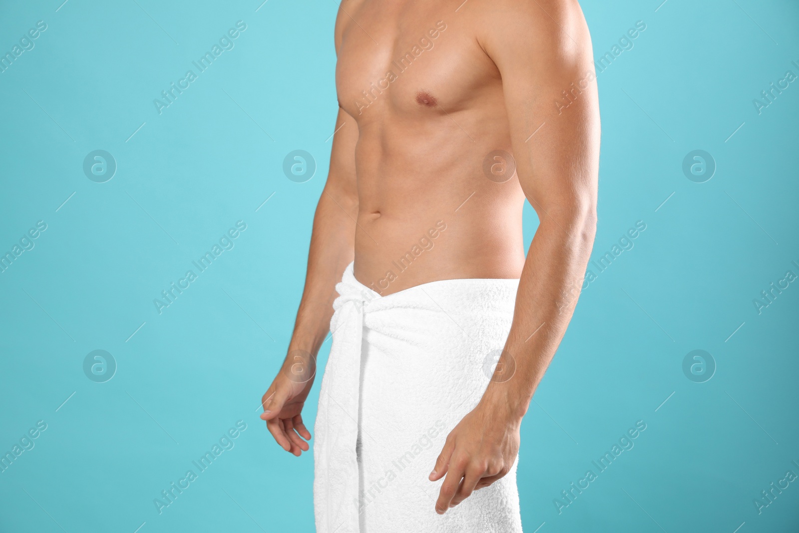 Photo of Young man with slim body on light blue background, closeup view. Space for text