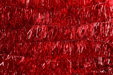 Photo of Bright red tinsel as background. Festive decoration