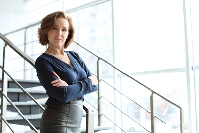 Female lawyer standing near stairs in office