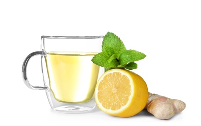 Glass cup with hot ginger tea, mint and lemon on white background