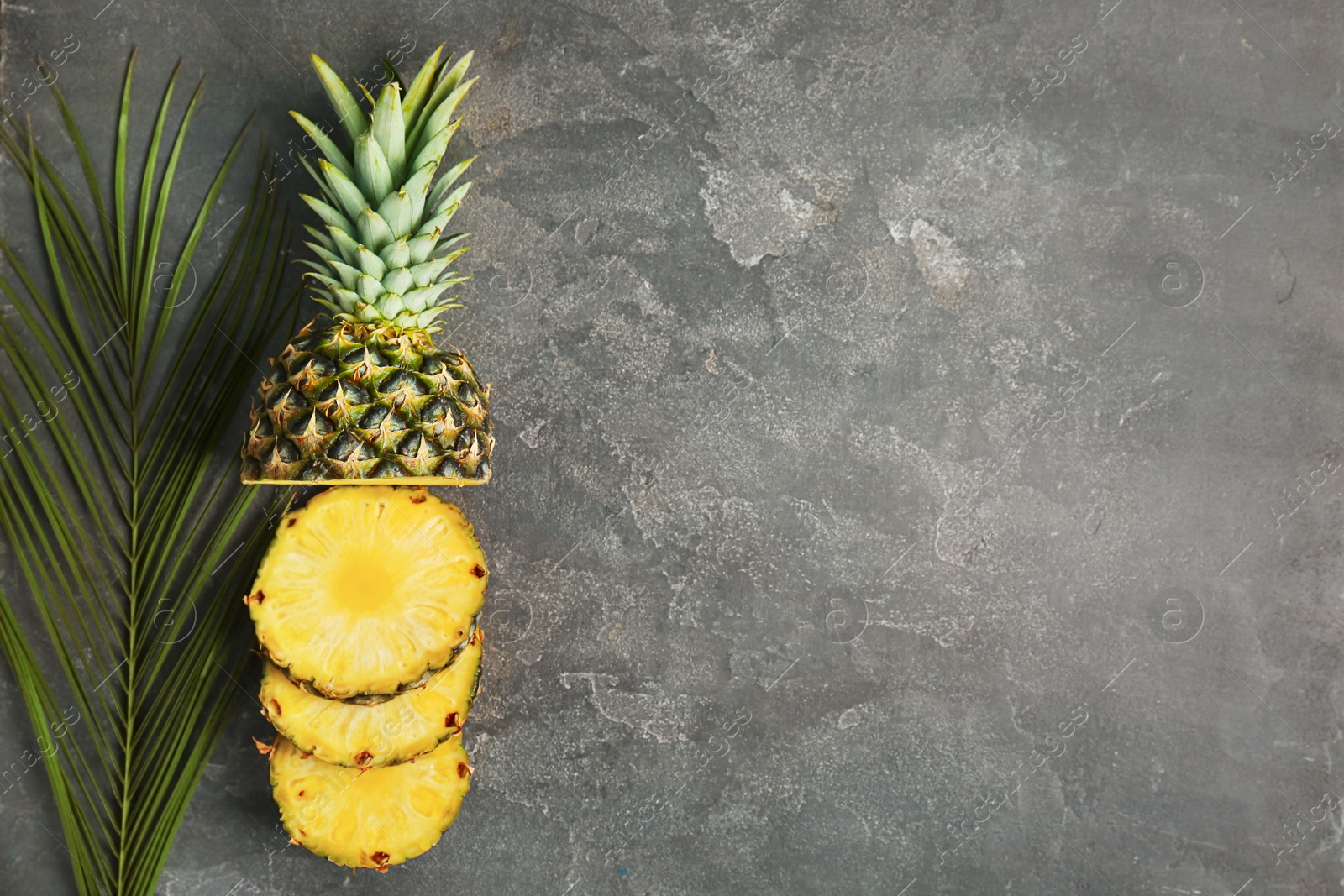 Photo of Cut fresh pineapple on grey background