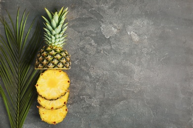 Photo of Cut fresh pineapple on grey background