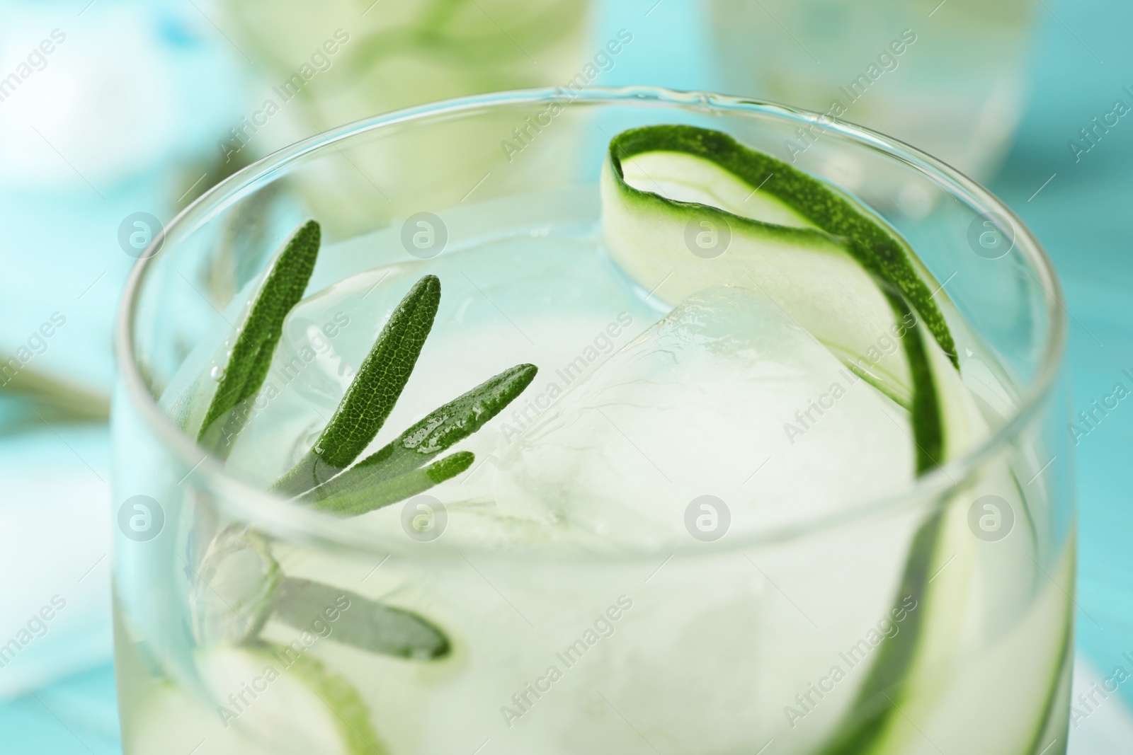 Photo of Glass of refreshing cucumber lemonade on table, closeup. Summer drink