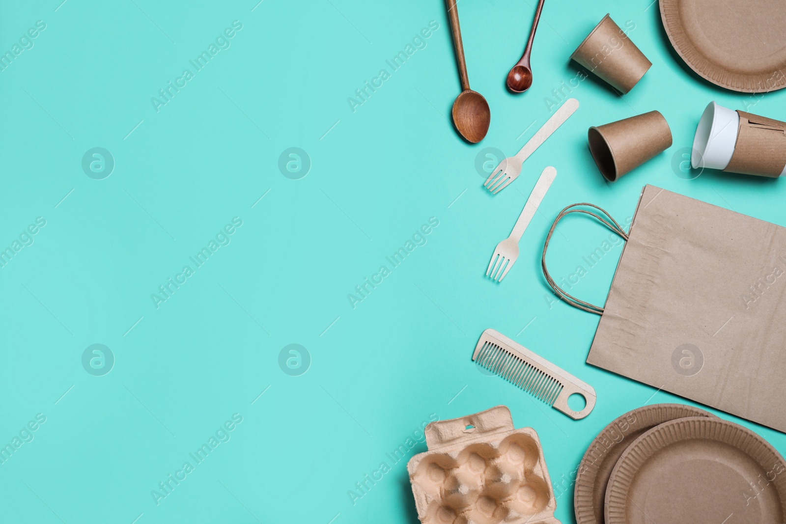 Photo of Different eco items on turquoise background, flat lay with space for text. Recycling concept