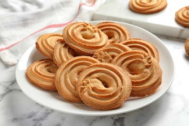 Photo of Plate with Danish butter cookies on marble table