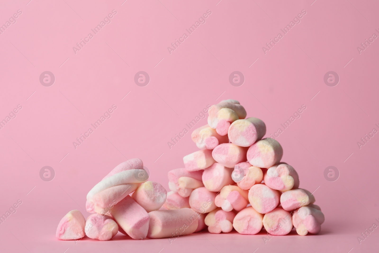 Photo of Stack of tasty marshmallows on pink background