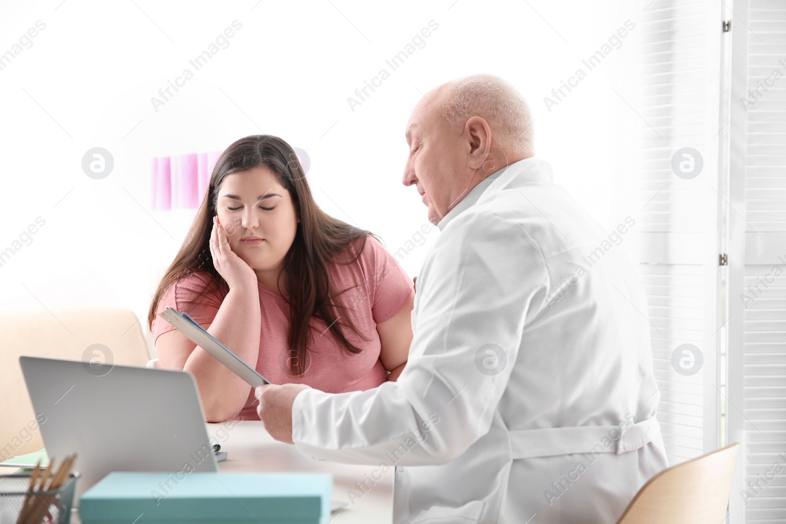 Photo of Overweight woman having consultation at doctor's office