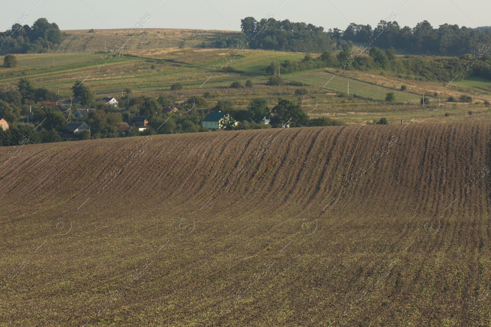 Photo of Beautiful view of agricultural field near village outdoors