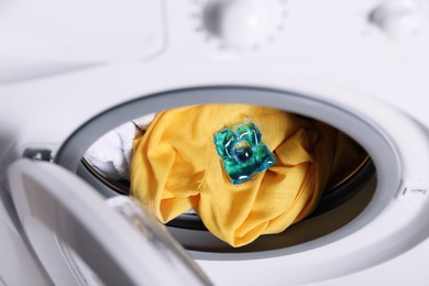 Photo of Laundry detergent capsule in washing machine drum, closeup view