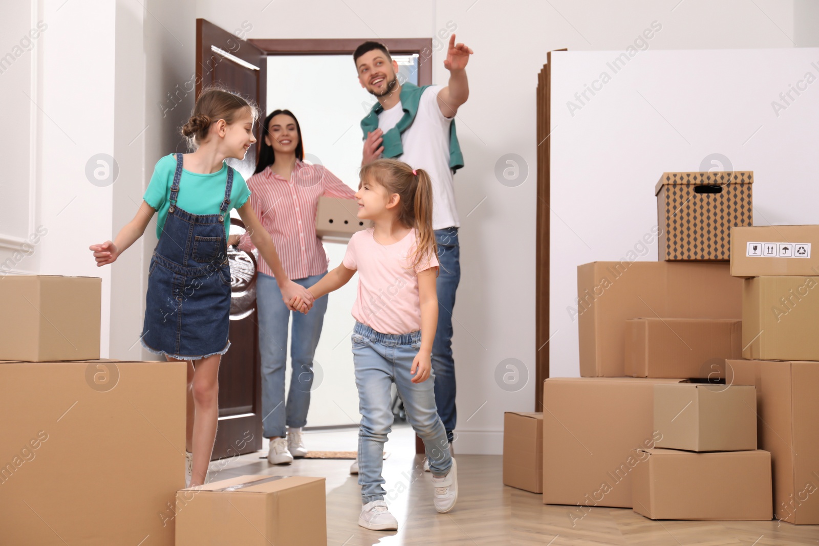 Photo of Happy family with children moving into new house