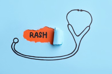 Word Rash written on orange background, view through hole in light blue paper with drawn stethoscope