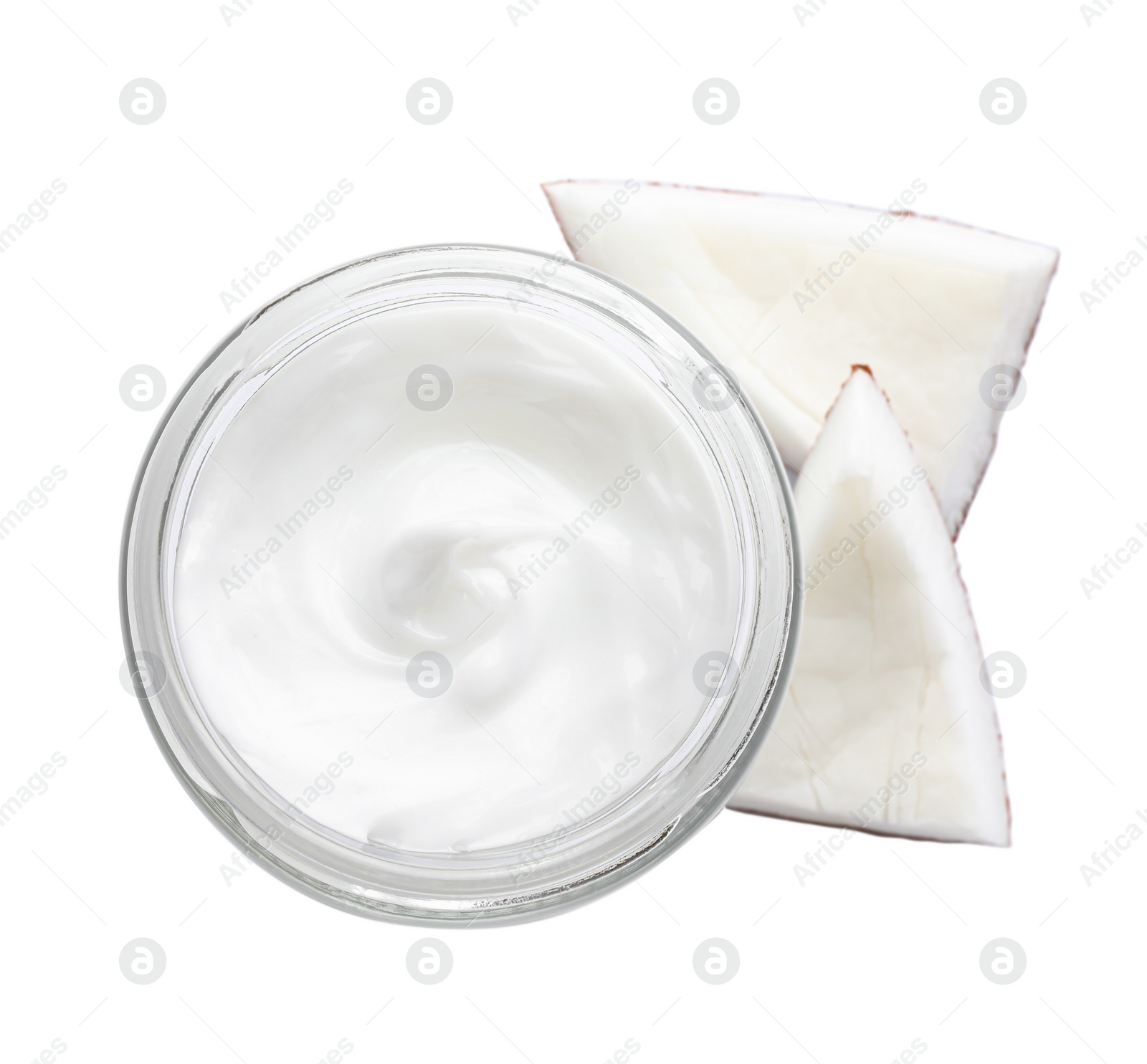 Photo of Jar of hand cream and coconut pieces on white background, top view