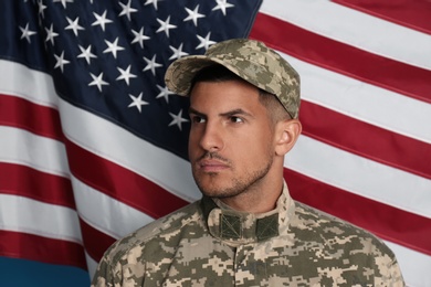 Photo of Soldier in uniform and United states of America flag on background