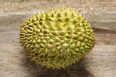 Photo of Ripe durian on wooden table, top view