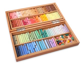 Photo of Set of soft pastels on white background in wooden box. Drawing material