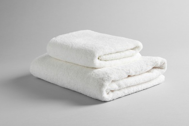 Fresh soft folded towels on light background