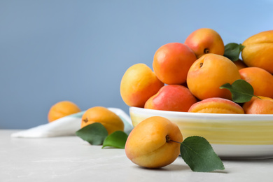 Photo of Delicious fresh ripe apricots on white table. Space for text