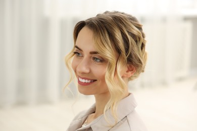 Photo of Smiling woman with beautiful hair style indoors