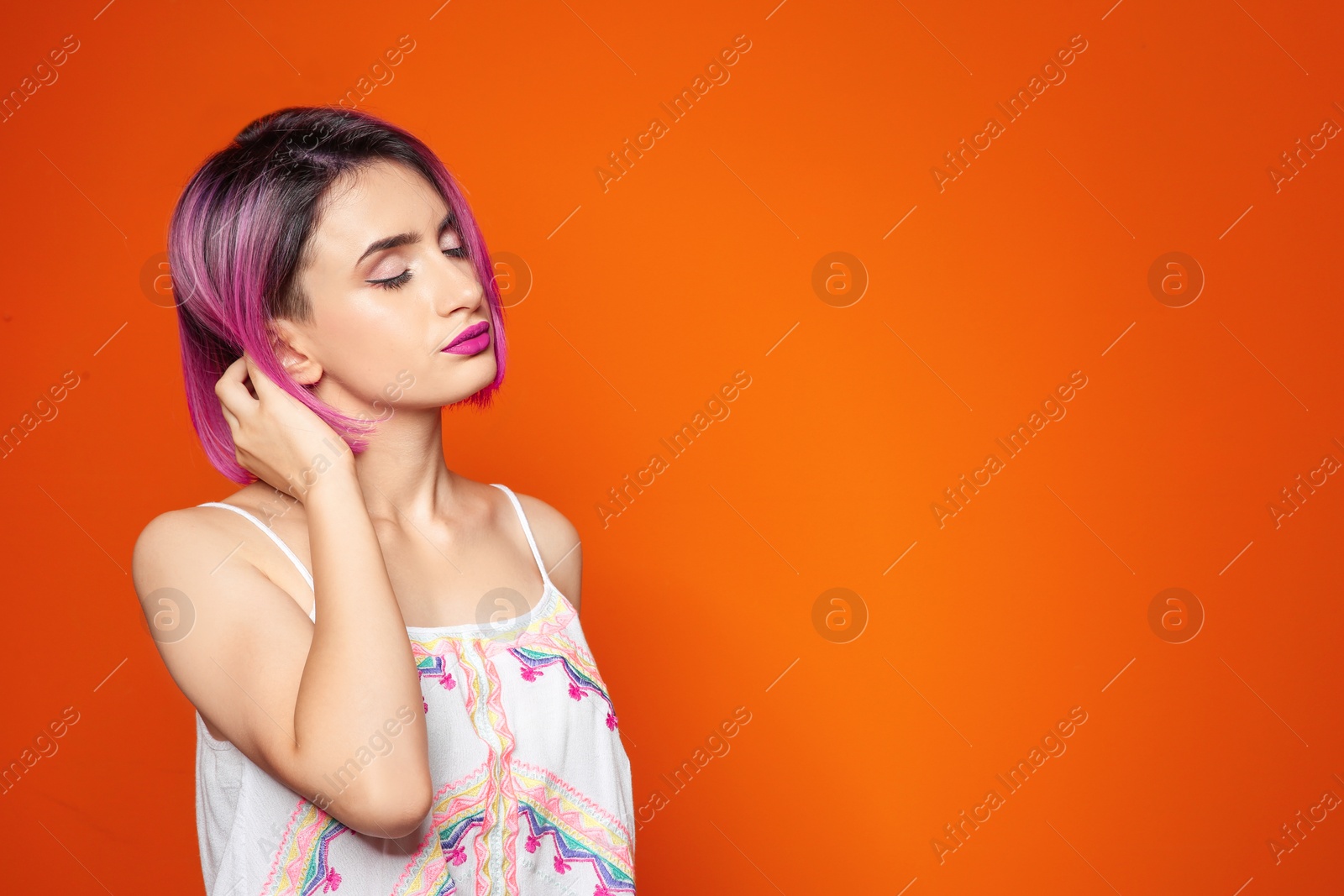 Photo of Young woman with trendy hairstyle against color background