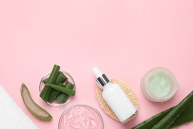 Photo of Flat lay composition with cosmetic products and cut aloe leaves on pink background. Space for text