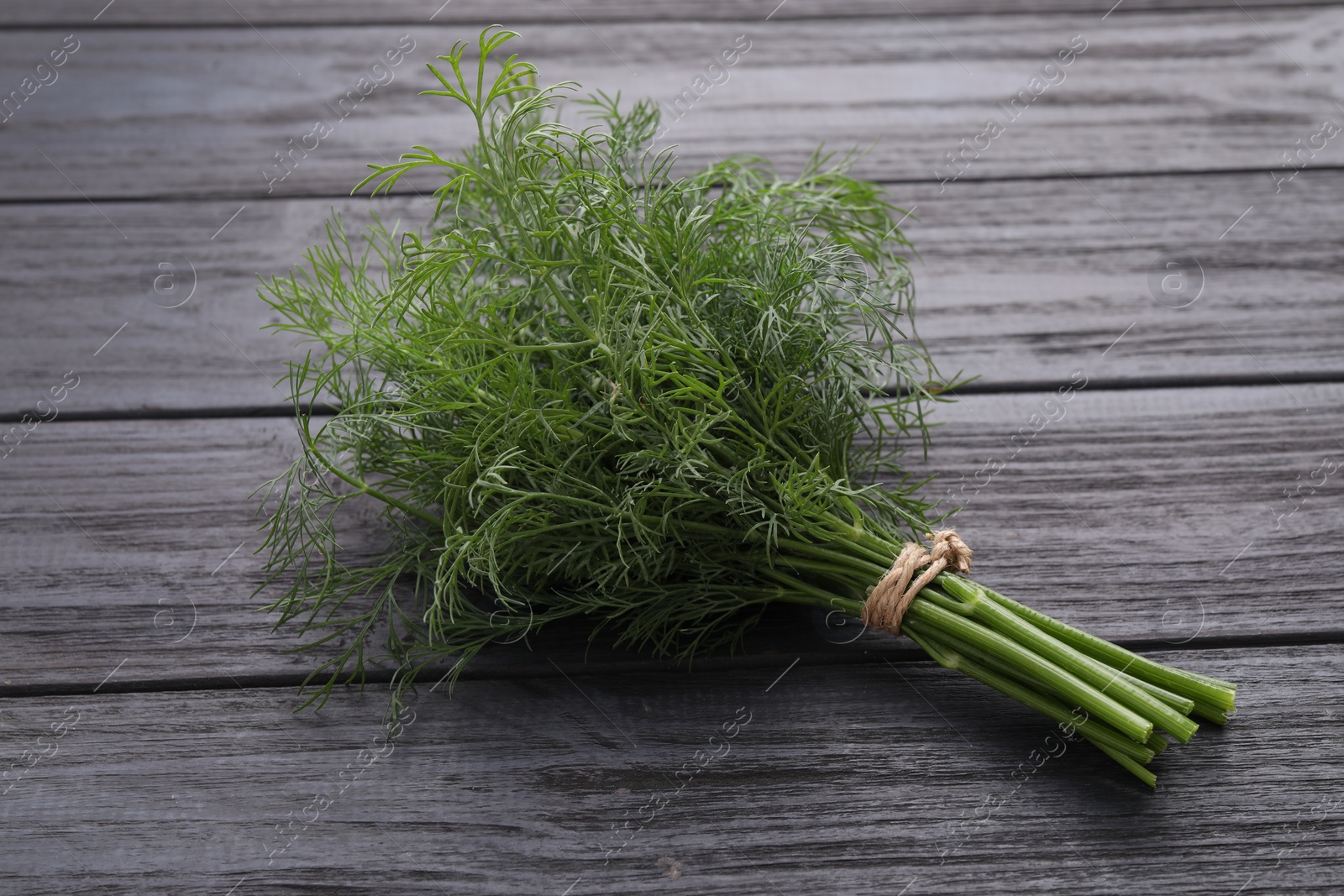 Photo of Bunch of fresh dill on wooden table