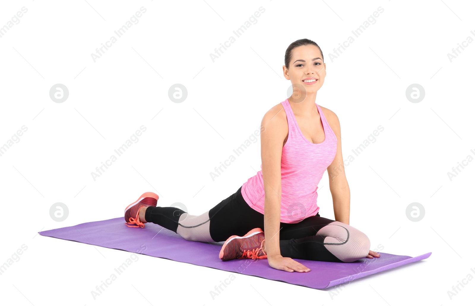 Photo of Young beautiful woman stretching on white background. Home fitness