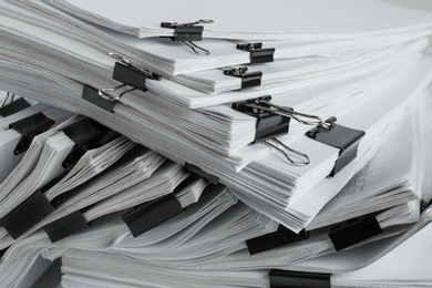 Photo of Pile of documents with binder clips, closeup