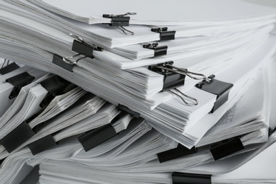 Pile of documents with binder clips, closeup