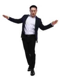 Businessman in suit posing on white background, low angle view