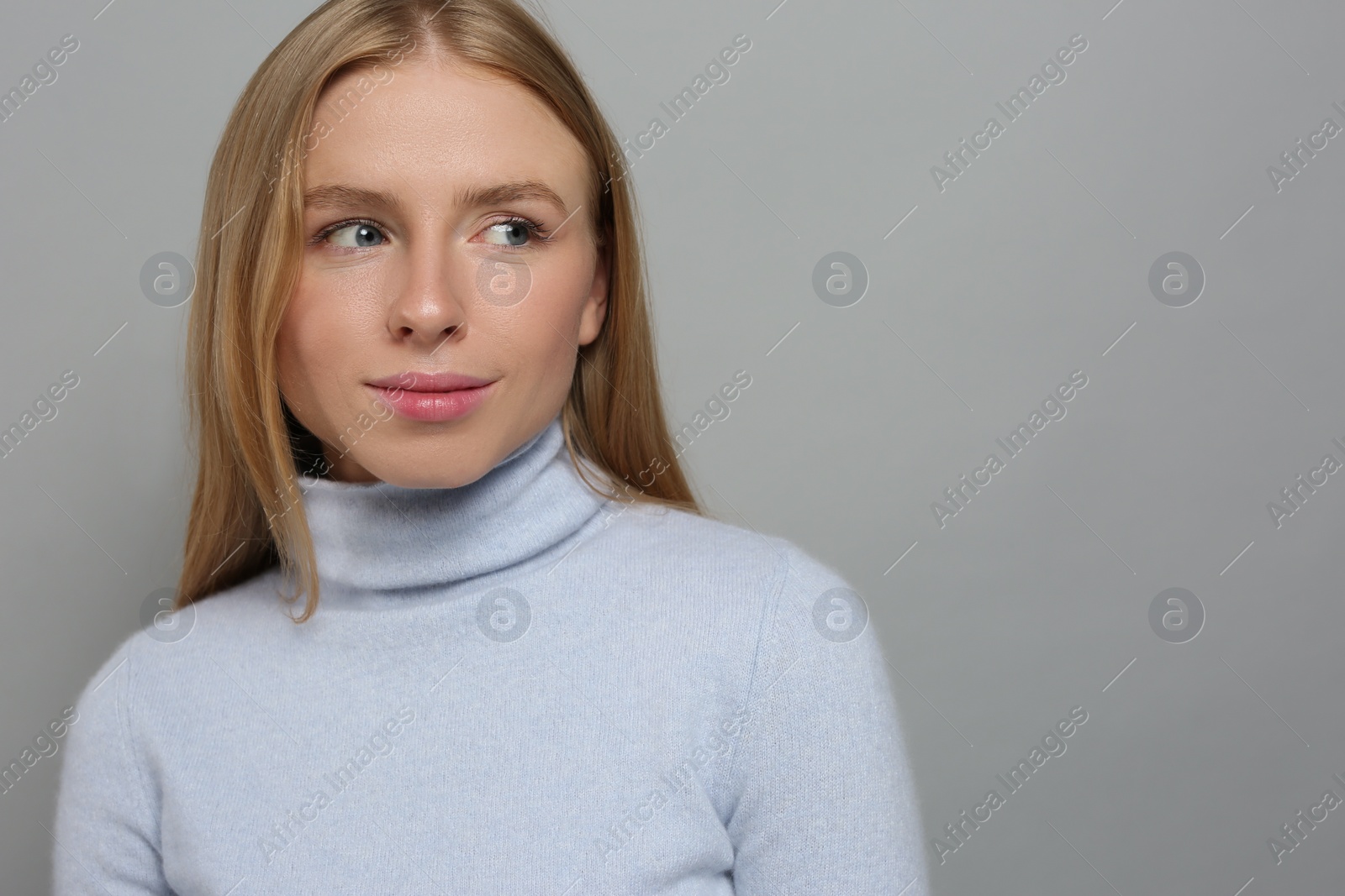 Photo of Portrait of beautiful young woman on grey background. Space for text