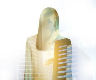 Double exposure of businesswoman and cityscape with office buildings