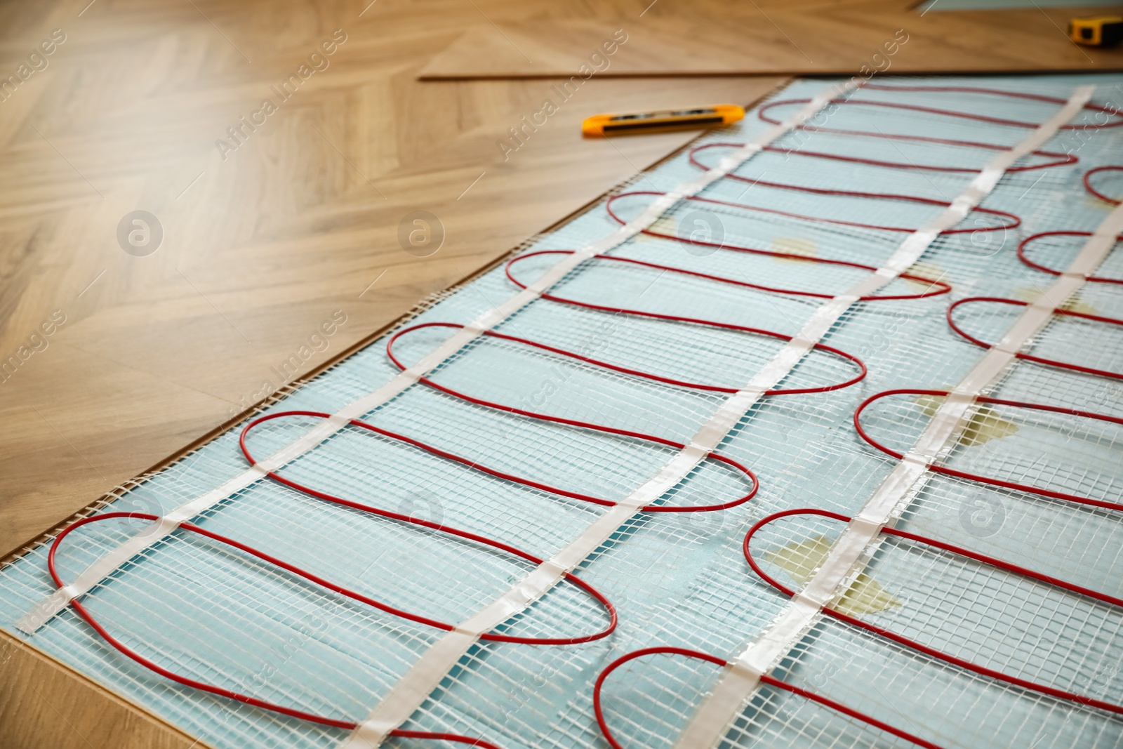 Photo of Installation of electric underfloor heating system indoors, closeup