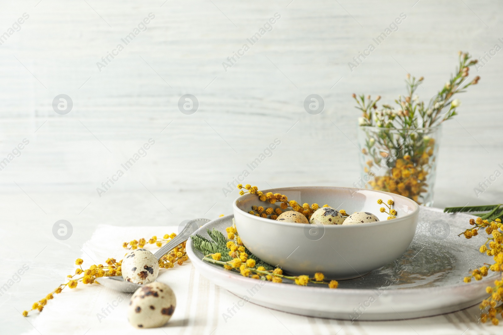 Photo of Festive Easter table setting with beautiful mimosa flowers. Space for text