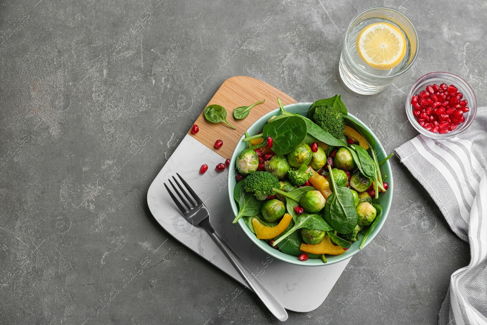 Photo of Tasty salad with Brussels sprouts served on grey table, flat lay