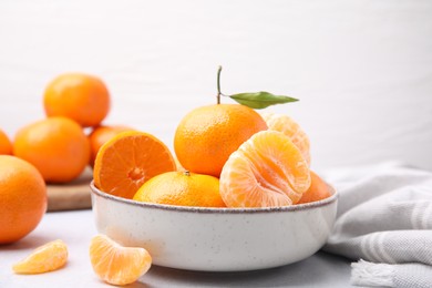 Fresh juicy tangerines on light grey table
