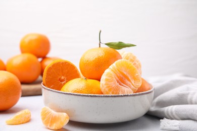 Photo of Fresh juicy tangerines on light grey table