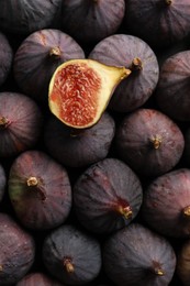 Tasty cut fig on whole ripe fruits, top view