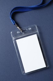 Photo of Blank badge with string on blue background, top view