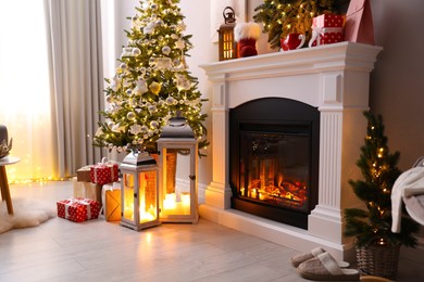 Beautiful fireplace, Christmas tree and other decorations in living room. Interior design