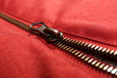 Photo of Red fabric with zipper as background, closeup view