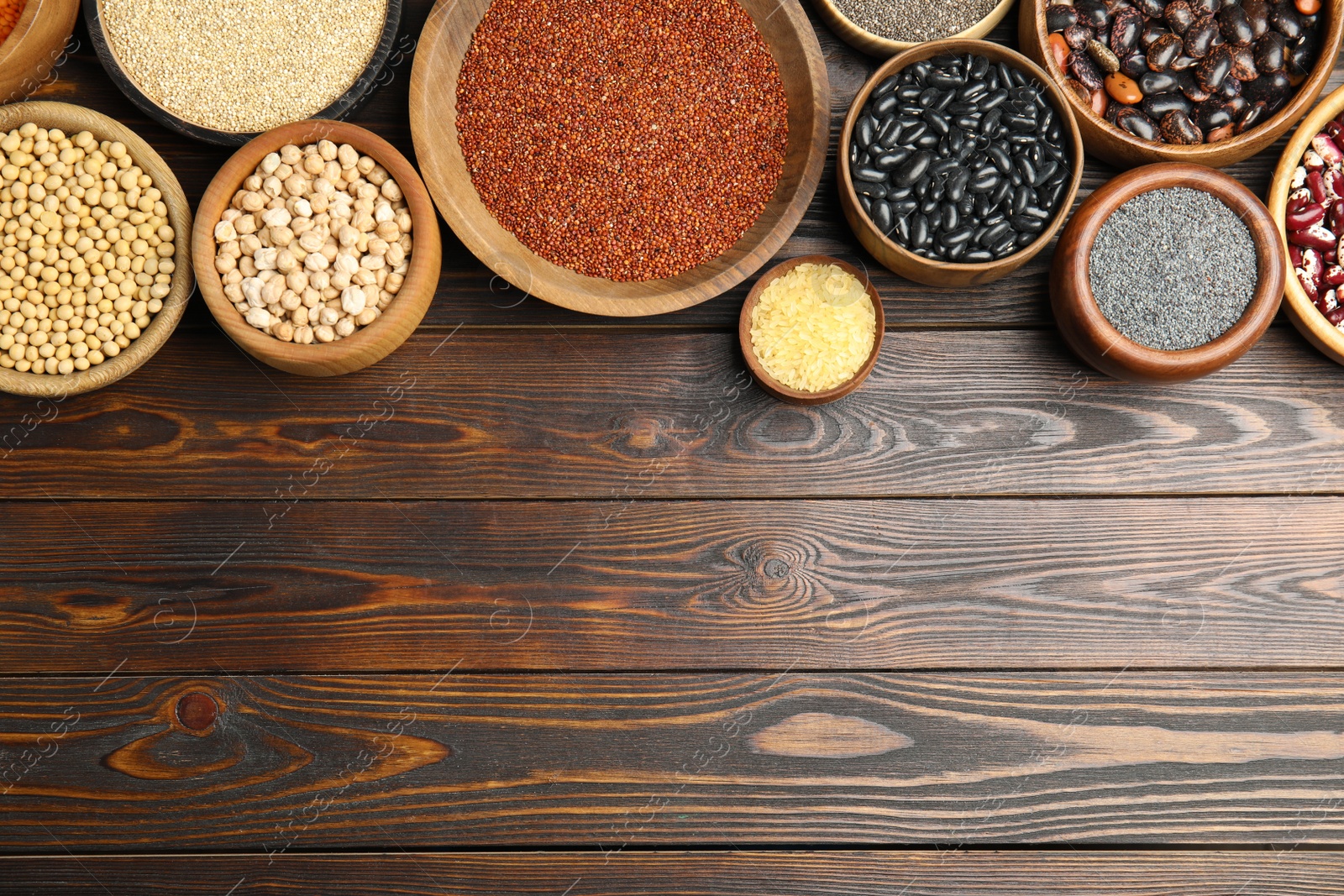 Photo of Different grains, seeds and space for text on wooden table, flat lay. Veggie diet