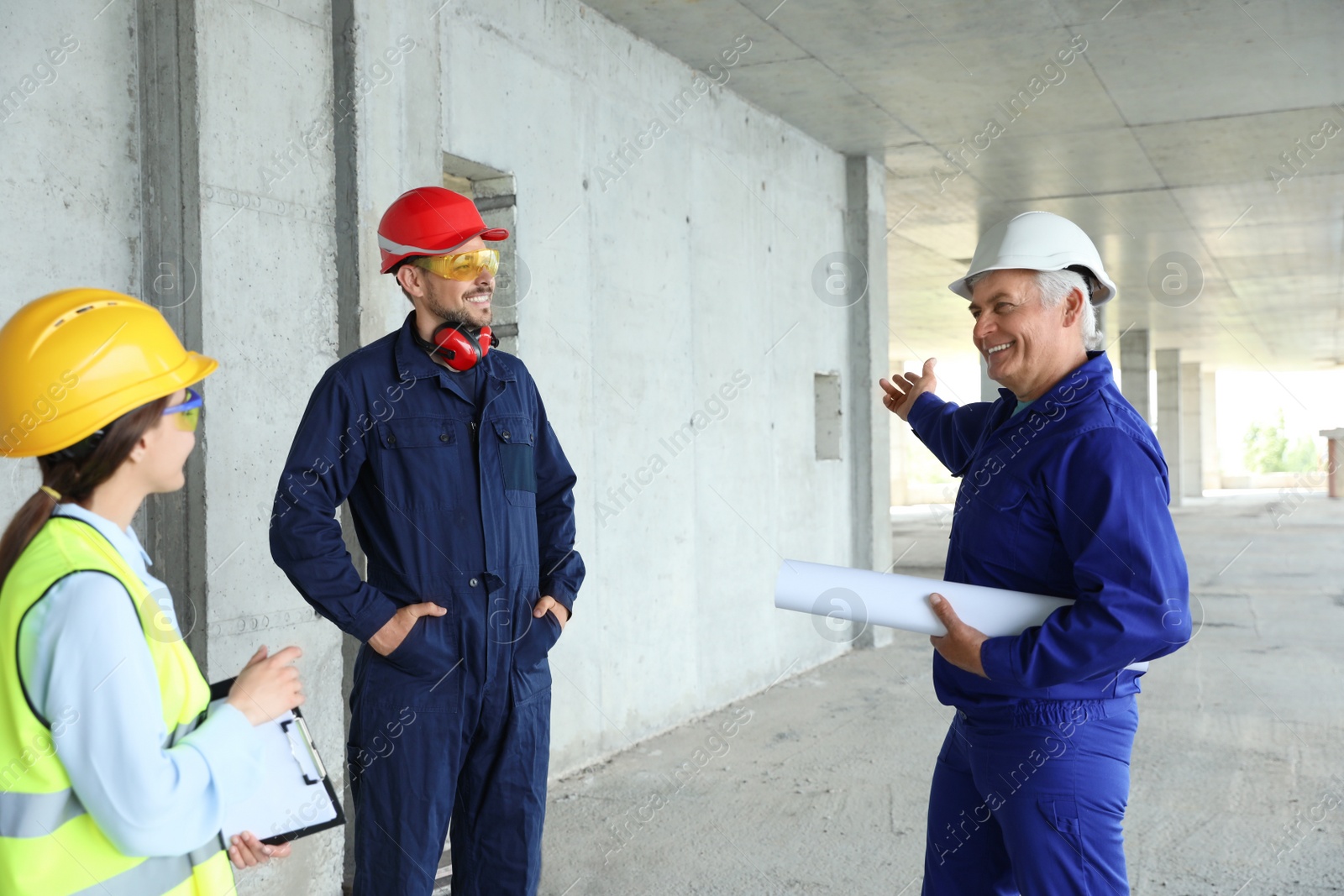 Photo of Professional engineers in safety equipment at construction site