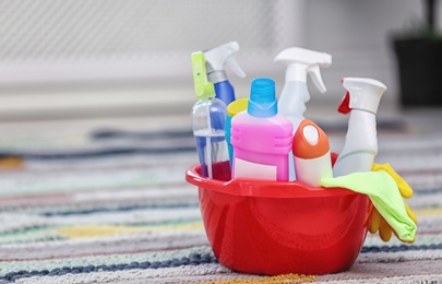 Basin with set of cleaning supplies indoors