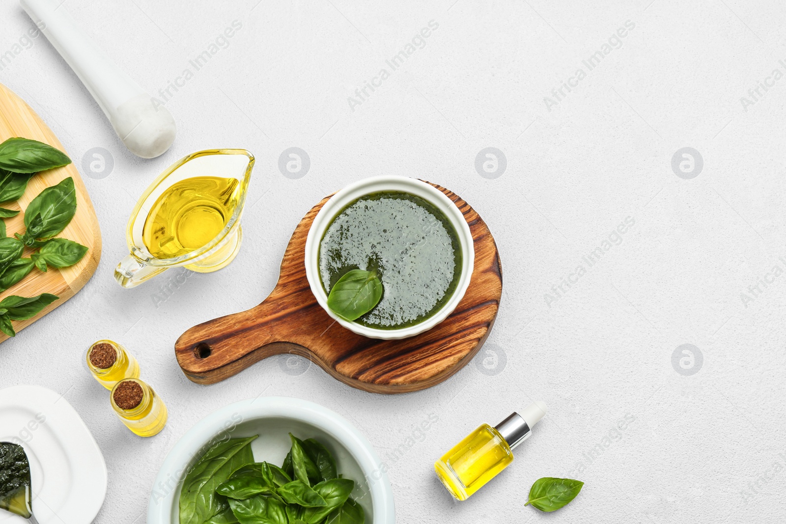 Photo of Composition with basil oil and leaves on white table. Space for text