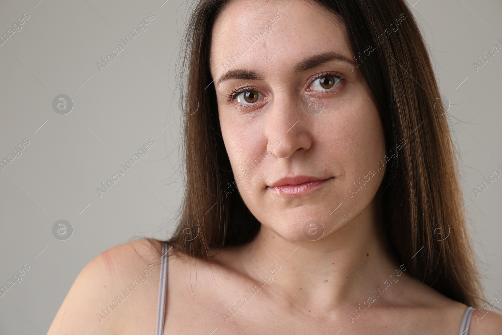 Photo of Portrait of beautiful young woman on light grey background, closeup