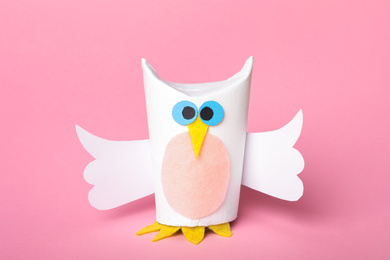 Photo of Toy owl made of toilet paper hub on pink background