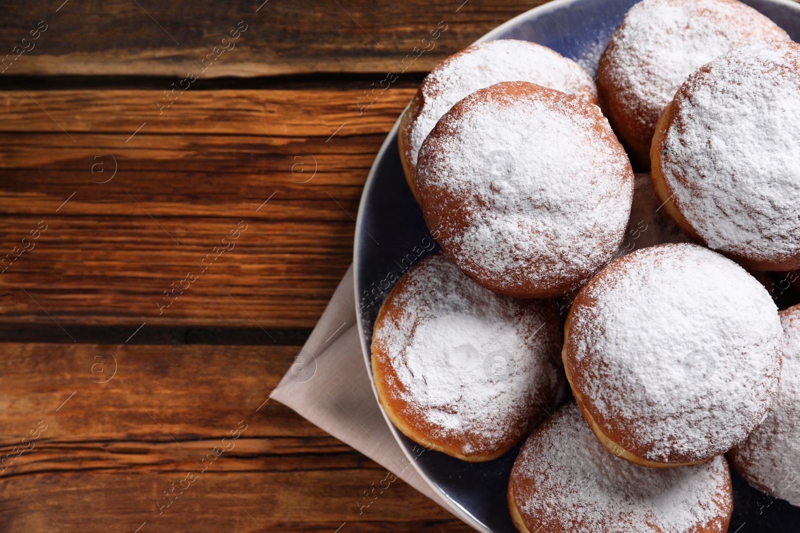 Photo of Delicious sweet buns on wooden table, top view. Space for text